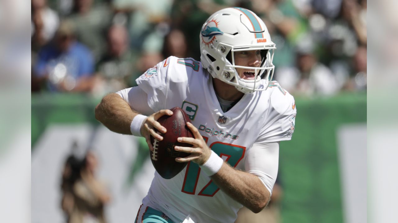 FILE - In this Oct. 14, 2018, file photo, injured Miami Dolphins  quarterback Ryan Tannehill cheers his team during the second half of an NFL  football game against the Chicago Bears, in