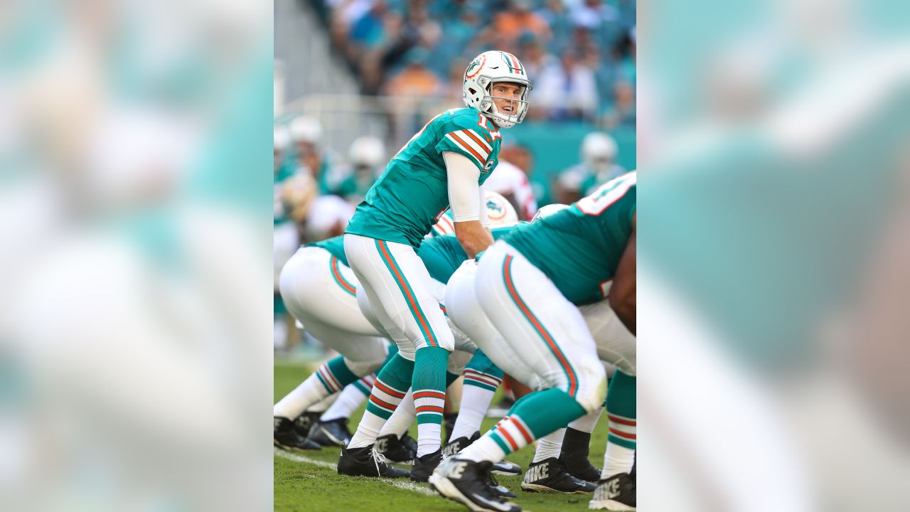 FILE - In this Oct. 14, 2018, file photo, injured Miami Dolphins  quarterback Ryan Tannehill cheers his team during the second half of an NFL  football game against the Chicago Bears, in