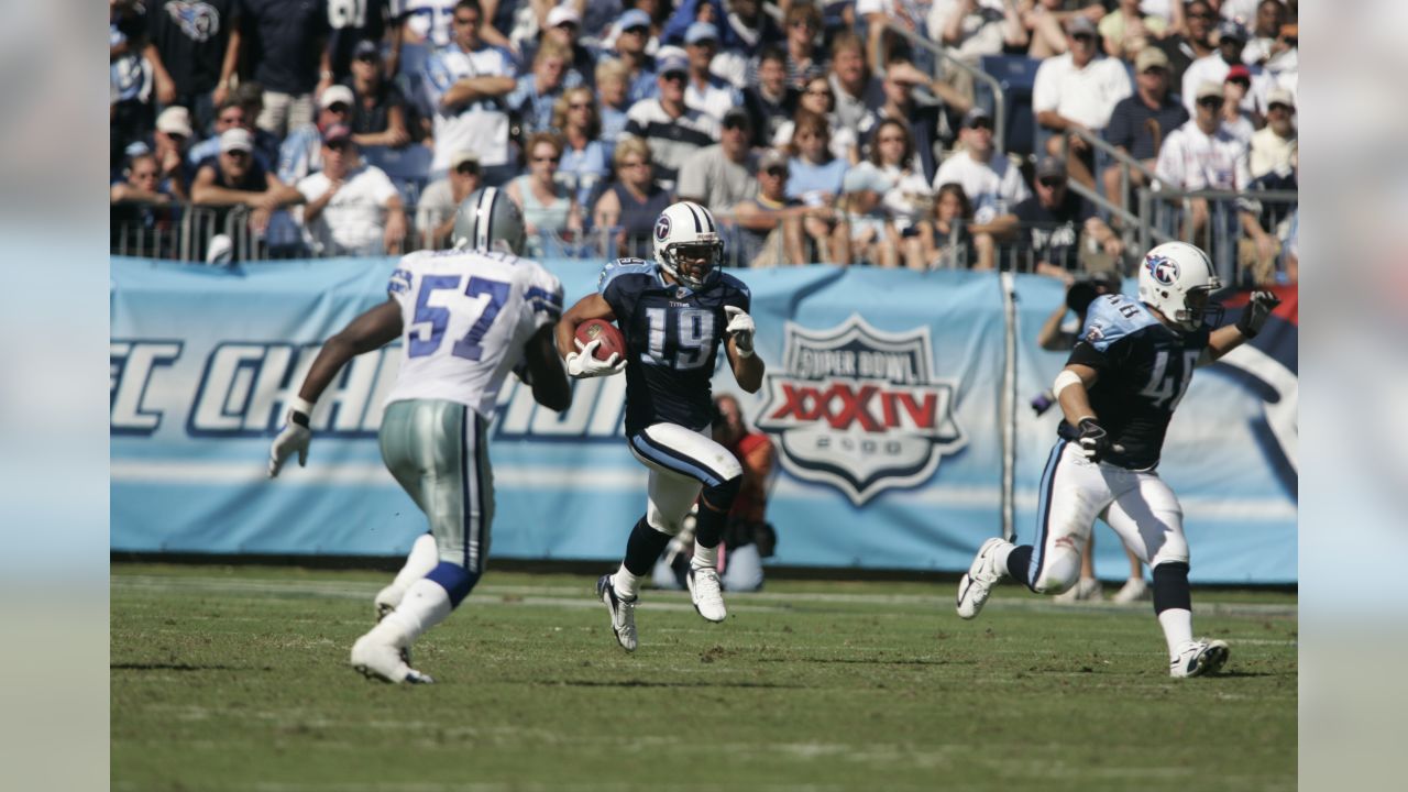 Dallas Cowboys receiver Terrell Owens (81) watches the action against the  Philadelphia Eagles from the sidelines in the fourth quarter. Teammate  Anthony Henry sits to the right. The Eagles defeated the Cowboys