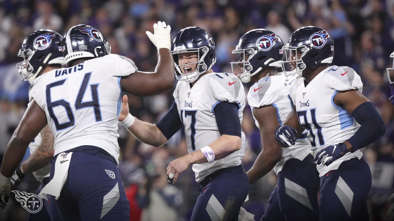 Baltimore Ravens quarterback Anthony Brown (12) runs with the ball as  Tennessee Titans linebacker Jack Gibbens (50) tries to stop him during the  second half of a preseason NFL football game, Thursday