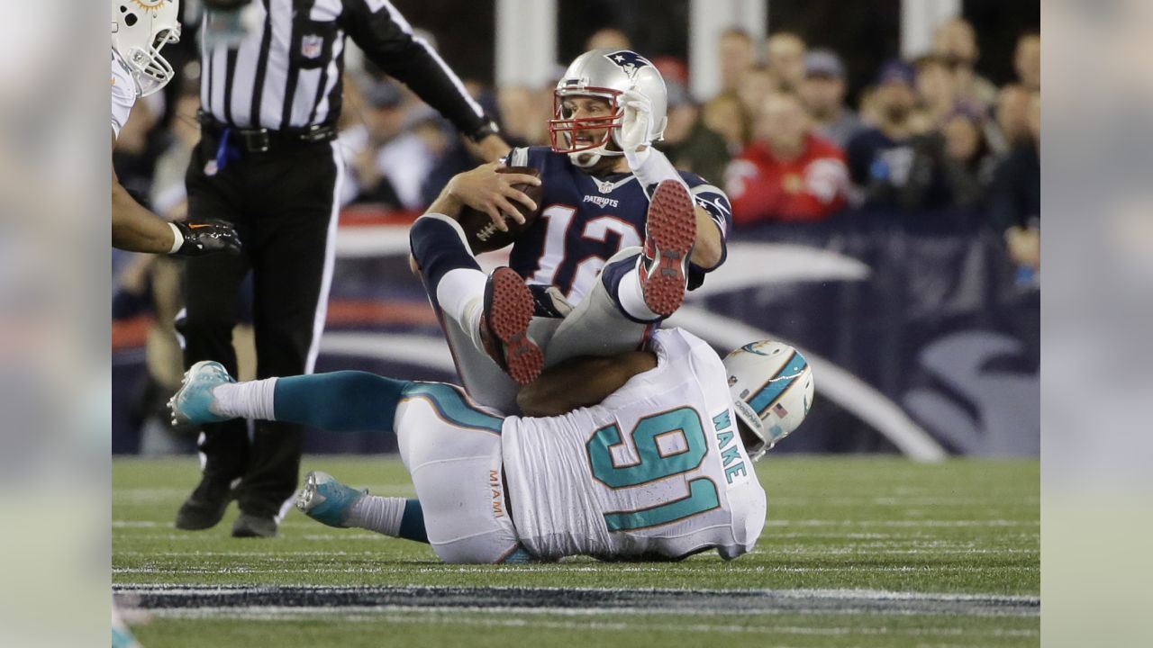 Randy Starks of the Miami Dolphins sacks Tom Brady of the New England  Patriots in the second quarter on Monday, September 12, 2011, at Sun Life  Stadium in Miami Gardens, Florida. (Photo