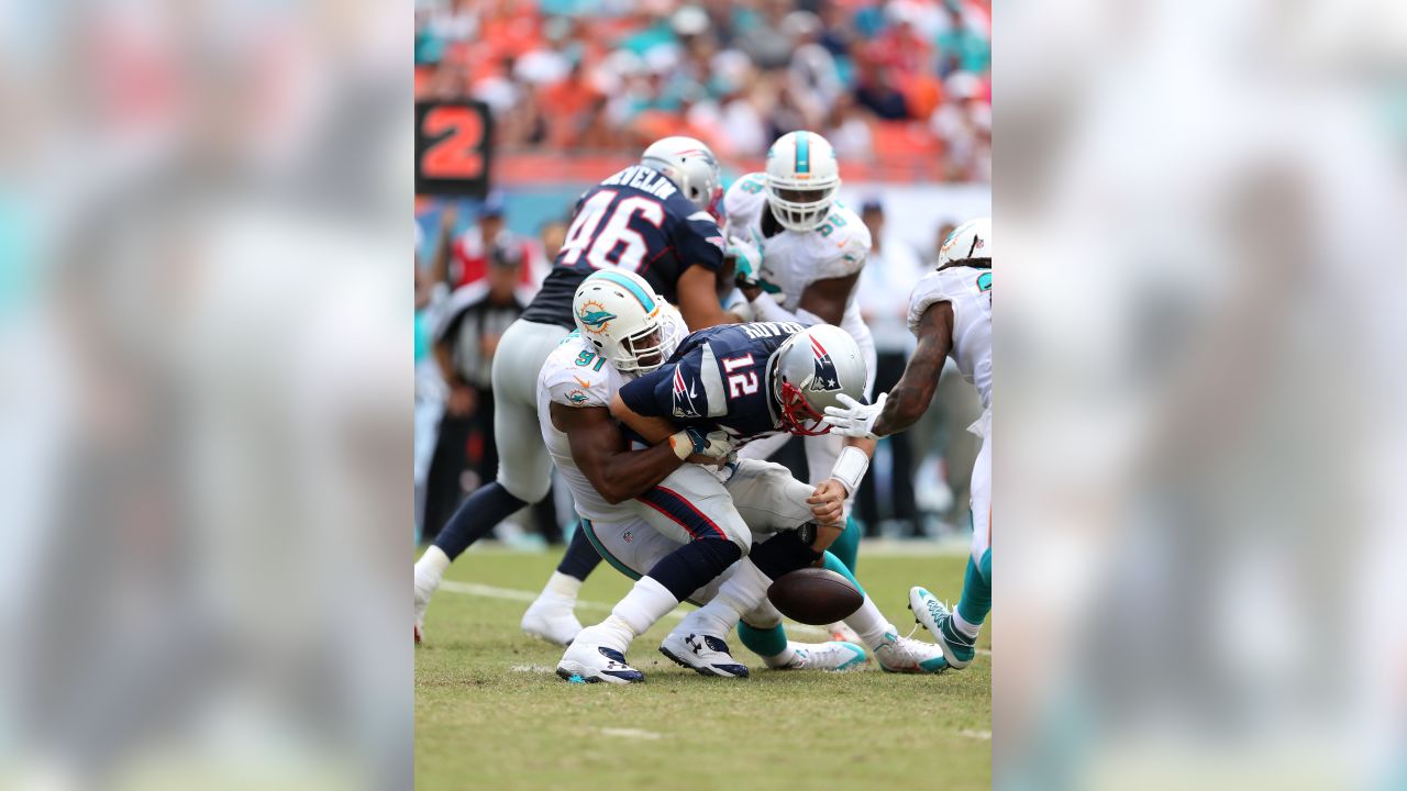 New England Patriots quarterback Tom Brady is sacked for a loss by Miami  Dolphins Koa Misi in second half action against the Miami Dolphins at Sun  Life Stadium in Miami on October