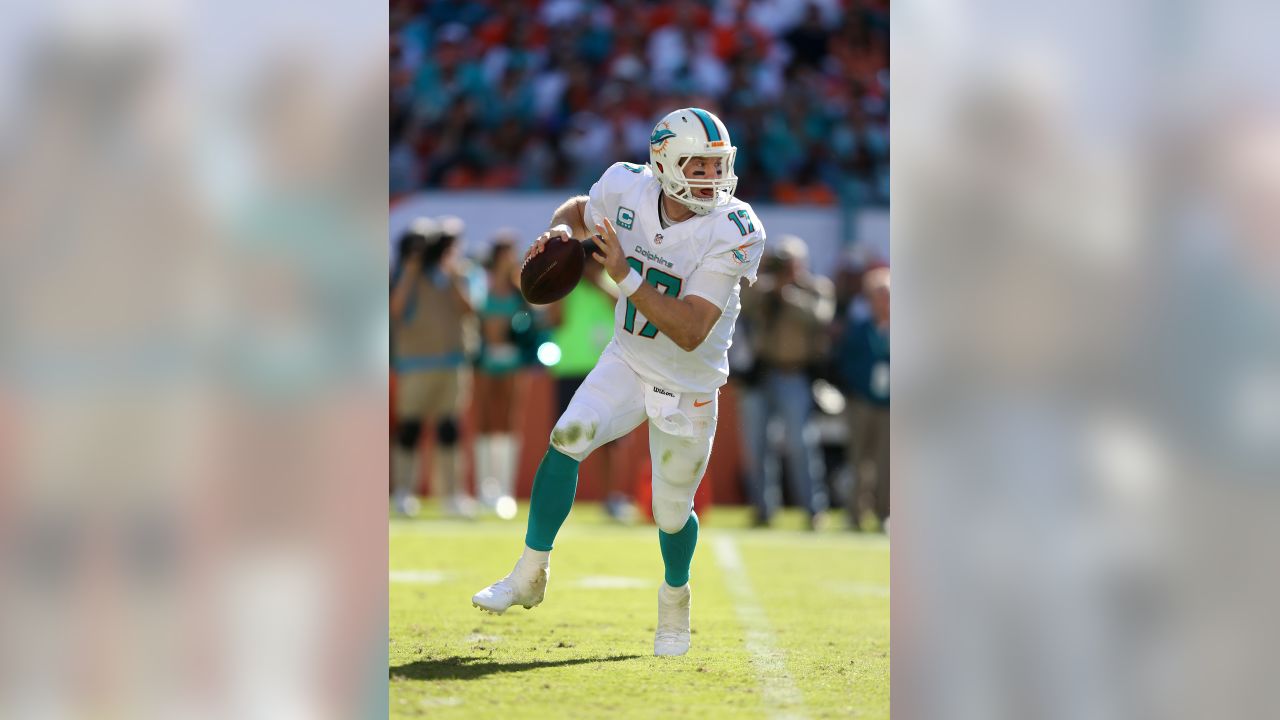 FILE - In this Oct. 14, 2018, file photo, injured Miami Dolphins  quarterback Ryan Tannehill cheers his team during the second half of an NFL  football game against the Chicago Bears, in