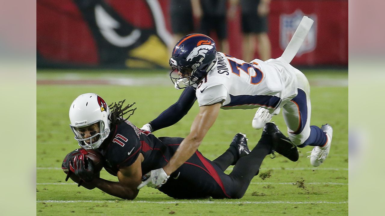 Arizona Cardinals wide receiver Larry Fitzgerald (11) is tackled by Denver Broncos free safety Justin Simmons (31) during the first half of an NFL football game, Thursday, Oct. 18, 2018, in Glendale, Ariz.