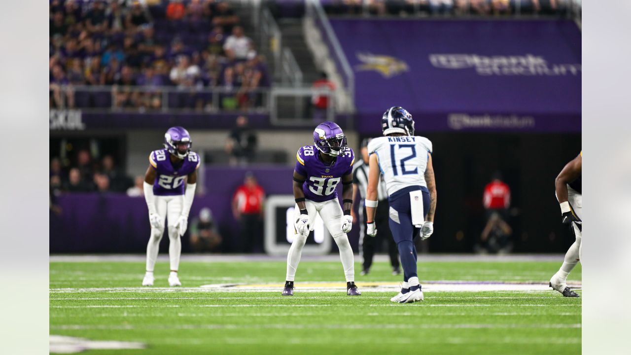 Minnesota Vikings guard Ezra Cleveland (72), middle, and offensive tackle  Christian Darrisaw (71), right, block as quarterback Kirk Cousins (8) looks  to pass during the second half of an NFL football game