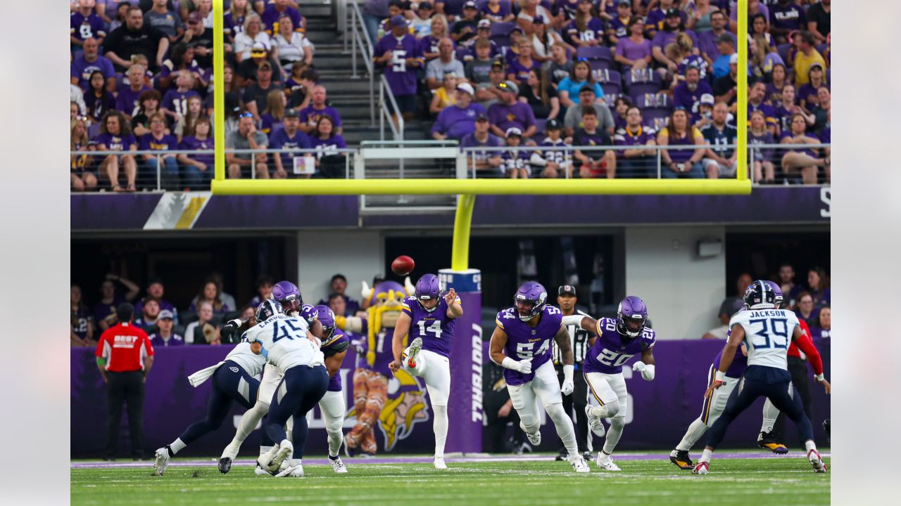 Minnesota Vikings guard Ezra Cleveland (72), middle, and offensive tackle  Christian Darrisaw (71), right, block as quarterback Kirk Cousins (8) looks  to pass during the second half of an NFL football game