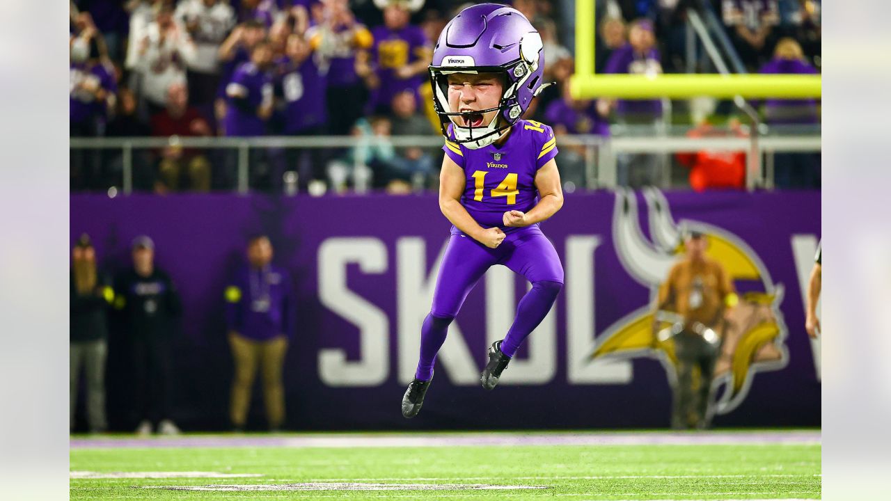 Minnesota Vikings fans wait for William Kwenkeu, right, to give