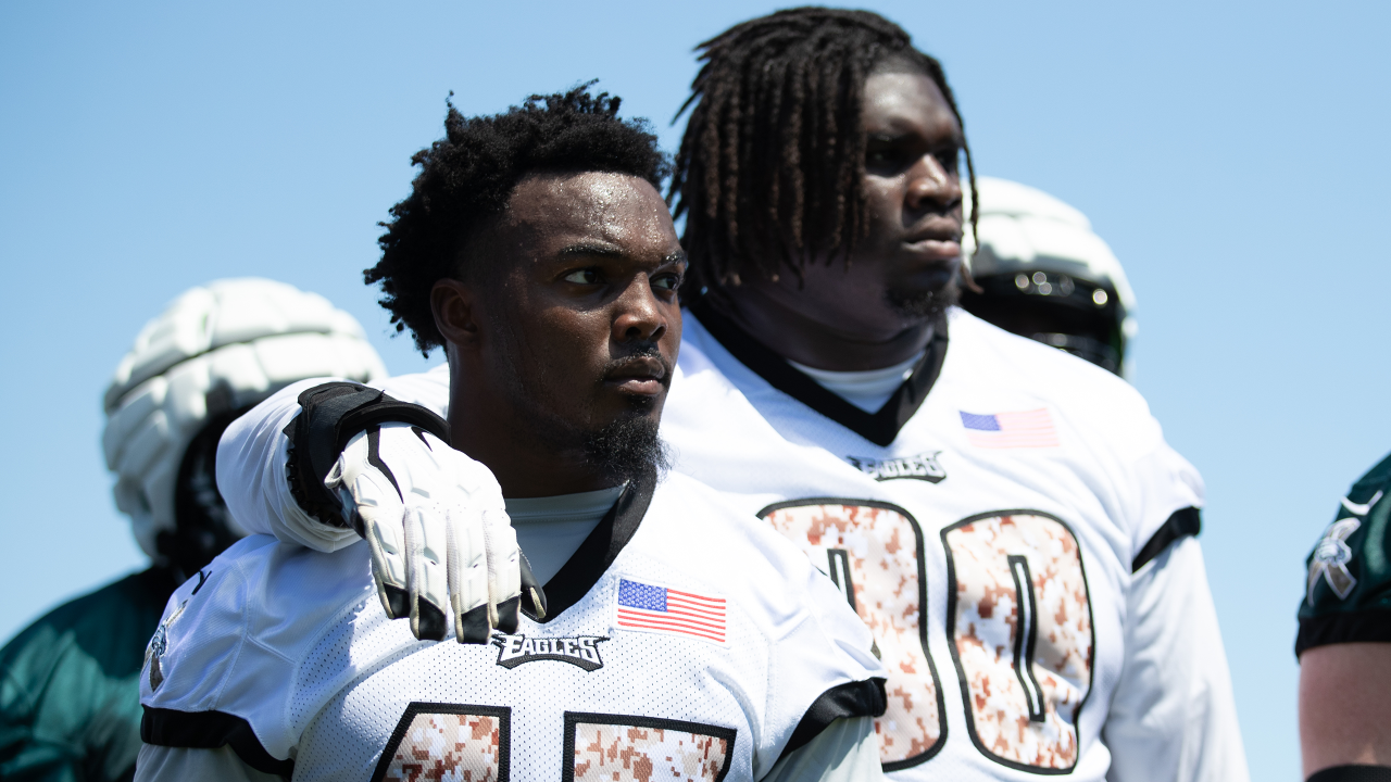 Philadelphia Eagles' Jalen Carter hands his jersey over to a member of the  Military during practice at NFL football training camp, Sunday, July 30,  2023, in Philadelphia. (AP Photo/Chris Szagola Stock Photo 