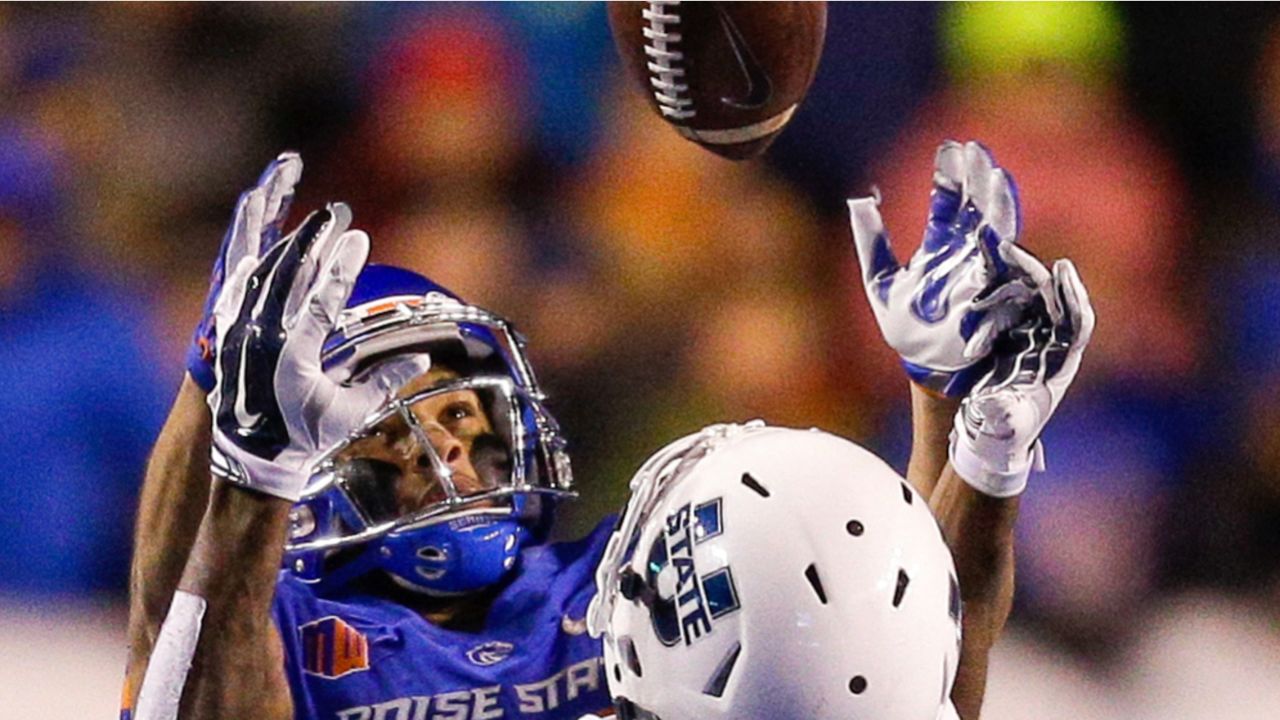 BOISE, ID - OCTOBER 21: Boise State Broncos cornerback Avery Williams (26)  leads his teammates onto the field with 'the hammer' during the regular  season game between the Wyoming Cowboys verses the