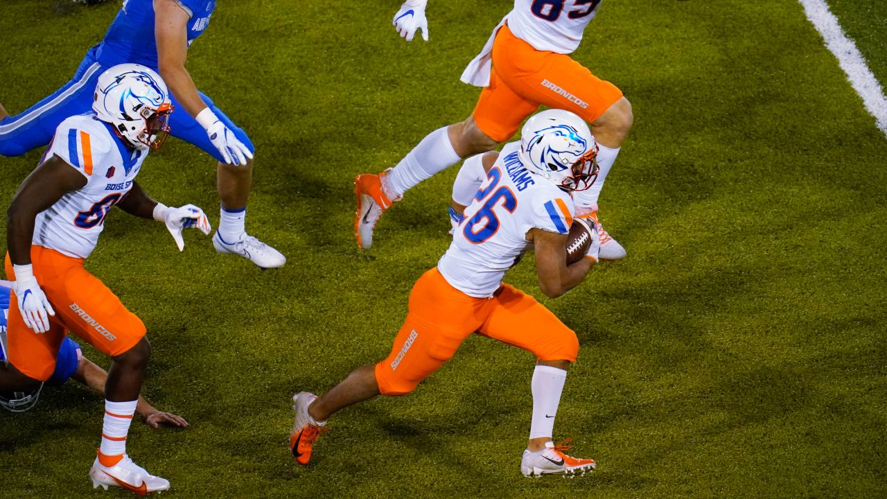 BOISE, ID - OCTOBER 21: Boise State Broncos cornerback Avery Williams (26)  leads his teammates onto the field with 'the hammer' during the regular  season game between the Wyoming Cowboys verses the