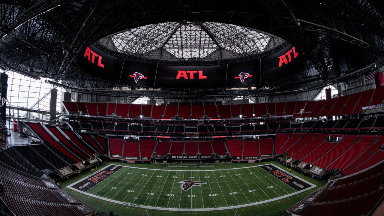 Watch as throwback logos and endzones are painted on the field at Mercedes-Benz  Stadium