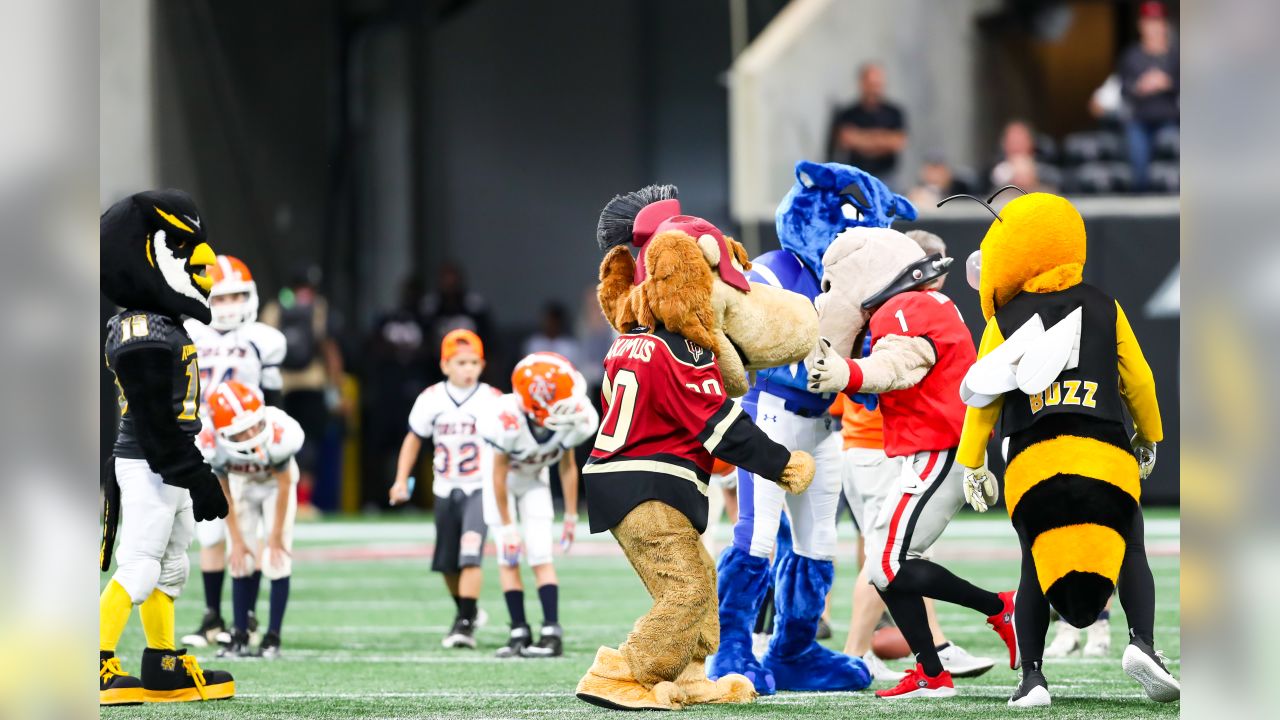 ATLANTA, GA - NOVEMBER 18: Falcons mascot Freddie shoots t-shirts into the  crowd before the Thursday night NFL game between the Atlanta Falcons and  the New England Patriots on November 18, 2021