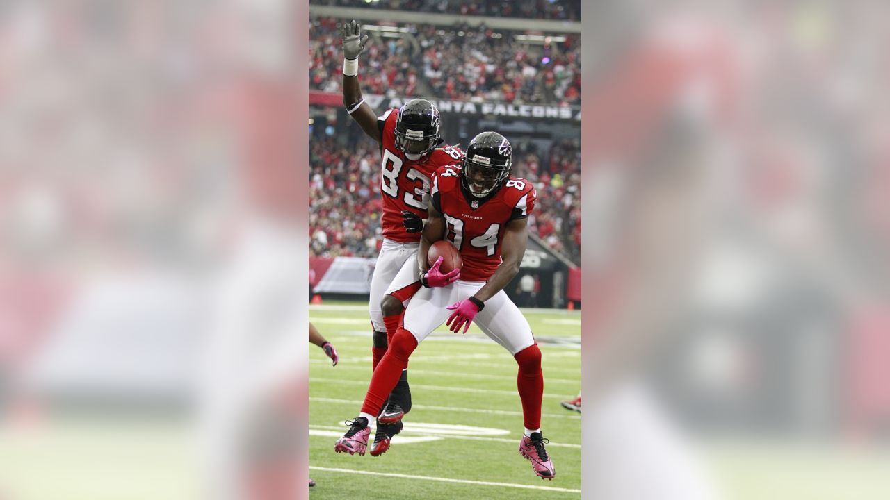 Atlanta Falcons wide receiver Roddy White (84) pulls defender Oakland  Raiders cornerback Michael Huff (24) during