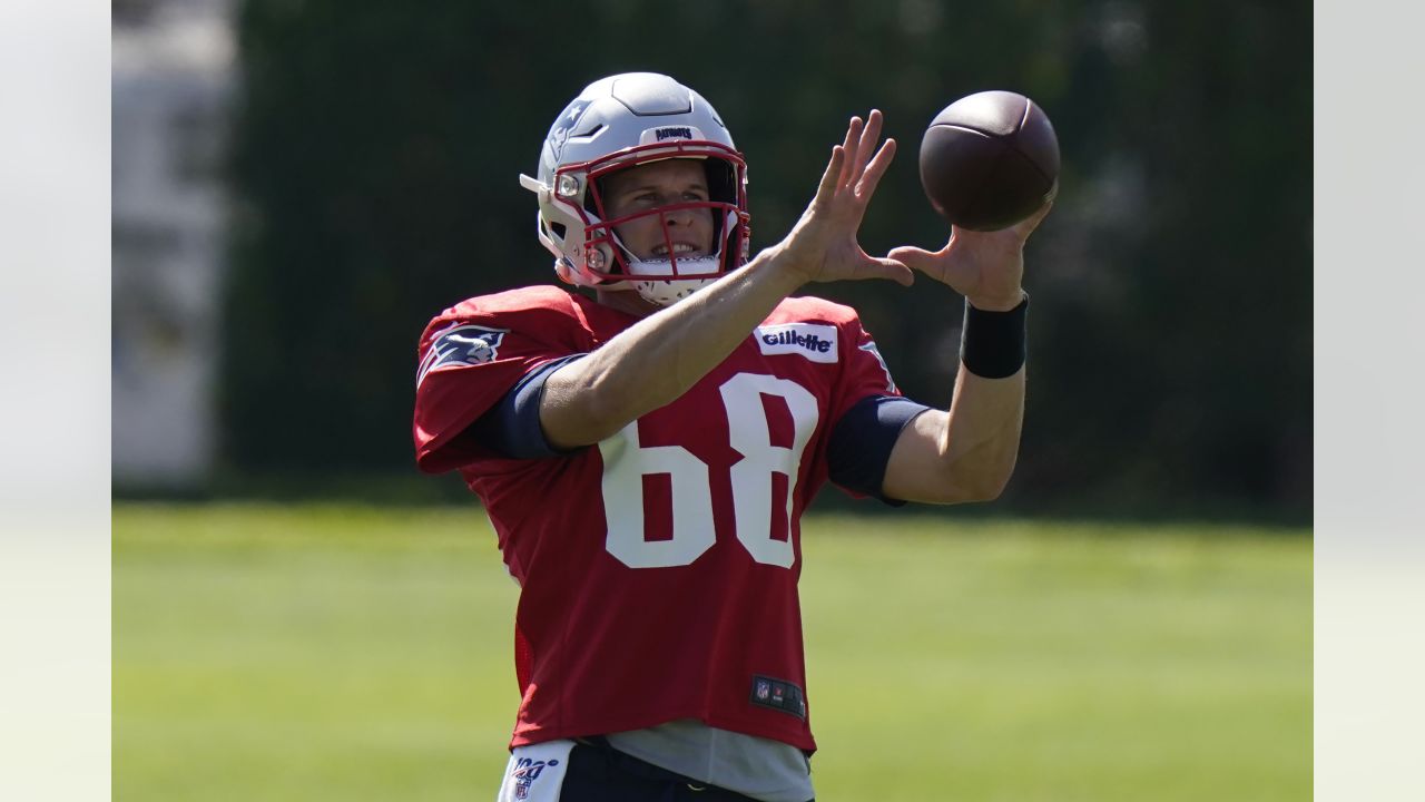 A fan walks by a giant helmet outside the New England Patriots Pro Shop  prior to an NFL football game, Sunday, Sept. 12, 2021, in Foxborough, Mass.  (AP Photo/Steven Senne Stock Photo 