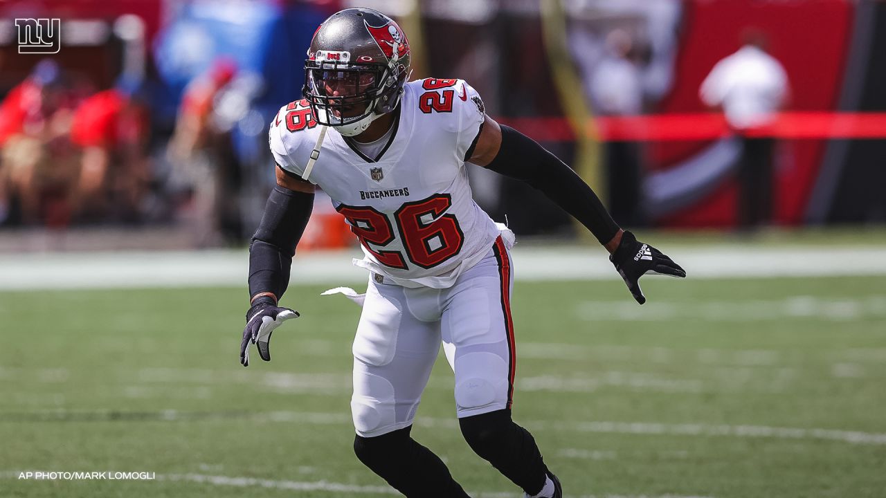 Tampa Bay Buccaneers safety Andrew Adams (26) grabs Buffalo Bills  quarterback Josh Allen (17) b …