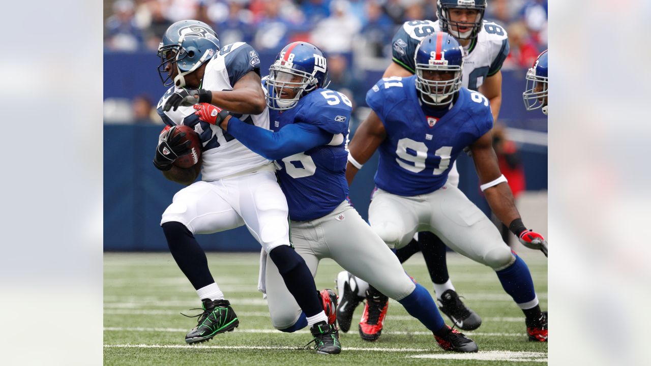 Seattle Seahawks wide receiver Deion Branch is tackled by New York Giants  safety Jason Bell after Branch made a catch in the first quarter of a NFL  football game Sunday, Sept. 24