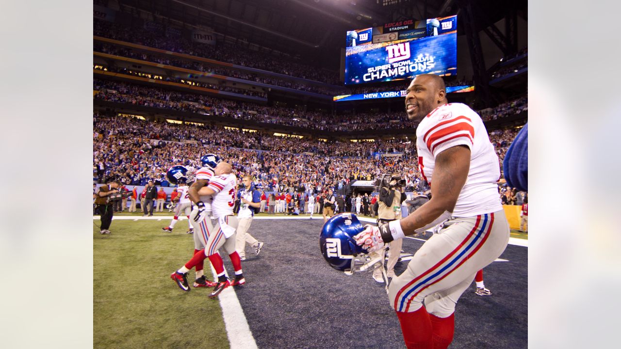 Defensive back Derrick Martin (22) of the New York Giants celebrates with  kids on the field at the end of Superbowl XLVI at Lucas Oil Stadium in  Indianapolis, Indiana on February 05