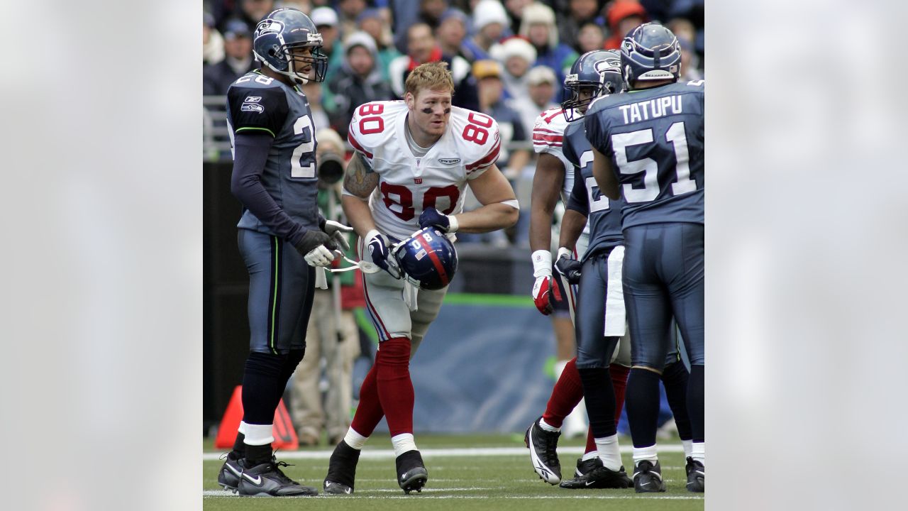 New York Giants Jake Ballard is held up by Seattle Seahawks Kam