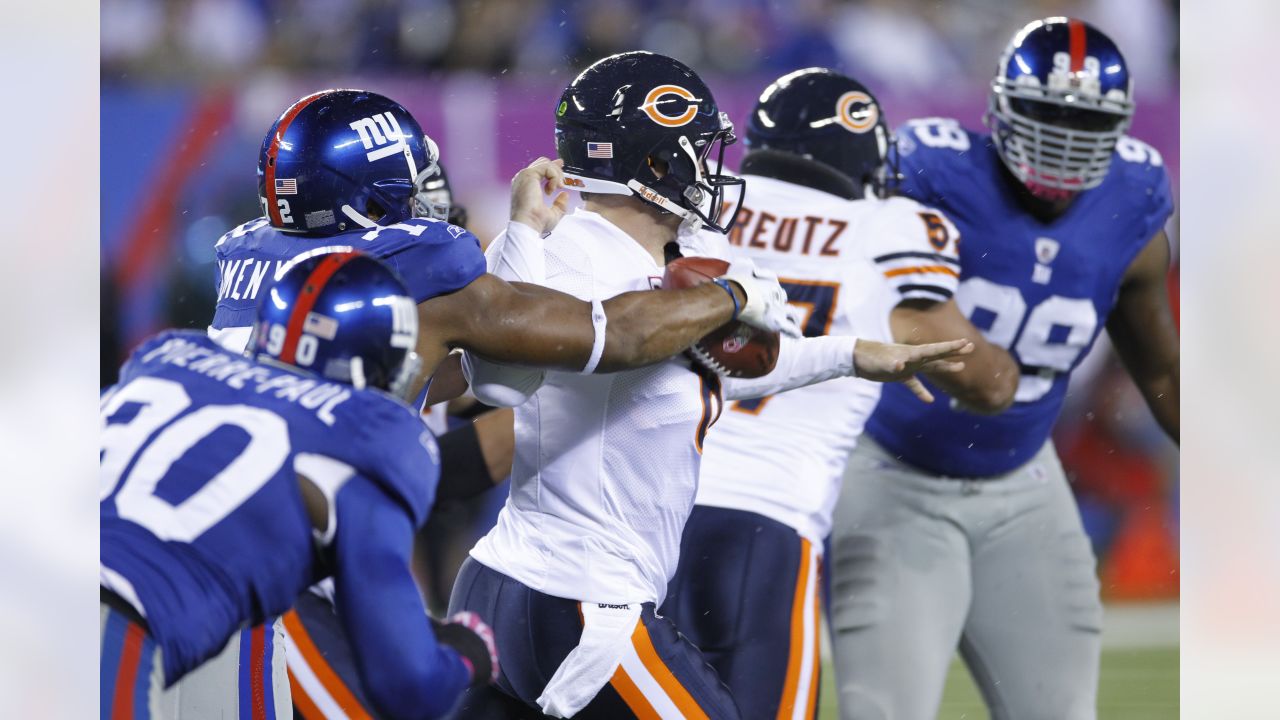 New York Giants quarterback Jeff Hostetler does a little scrambling to  avoid Chicago Bears Steve McMichael (rear) and Trace Armstrong (93) during  third quarter action in NFL playoff game, Sunday, Jan. 14