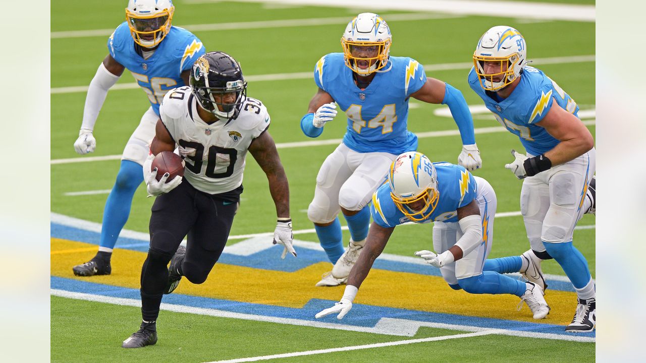 JACKSONVILLE, FL - NOVEMBER 28: Jacksonville Jaguars running back James  Robinson (25) runs with the ball during the game between the Atlanta  Falcons and the Jacksonville Jaguars on November 28, 2021 at