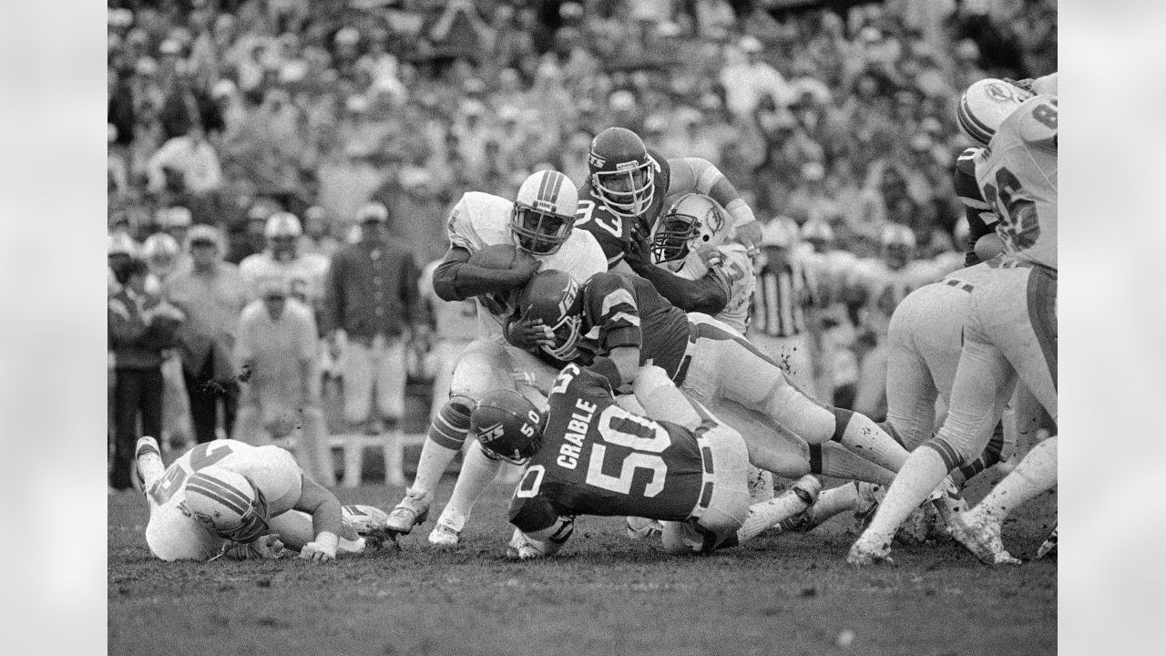 Miami Dolphin back Jim Kiick (21) seems totally unaware that he is about to  be trounced by New York Jets John Elliott (80) during action in their AFL  game Sunday afternoon Dec.