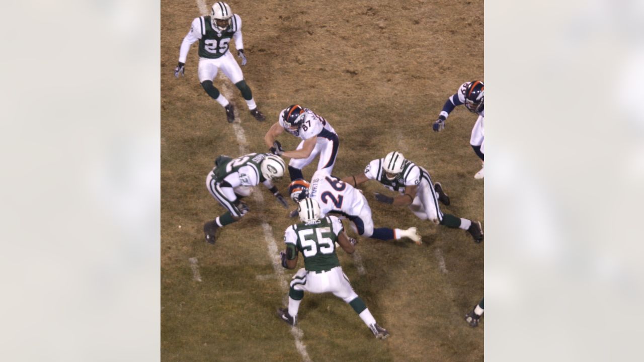 Floyd Little (44) of the Denver Broncos avoids the tackle of Jets' Steve  O'Neal (20) and continues on his way to the Jets 1-yard line where he was  tripped up in Denver