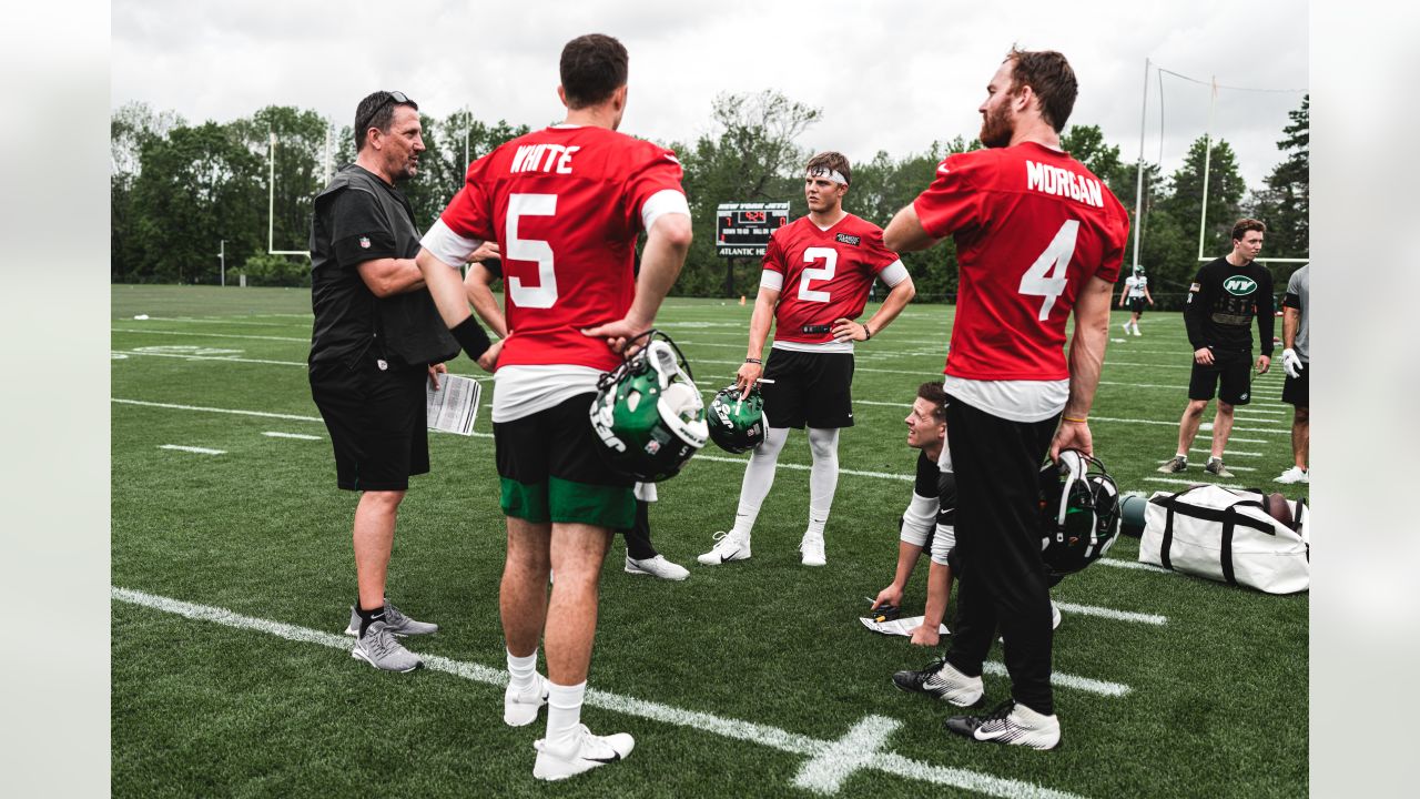 New York Jets quarterback Zach Wilson (2), offensive coordinator Mike  LaFleur and quarterback Mike White (5) make their way to a joint NFL  football training camp practice with the Green Bay Packers