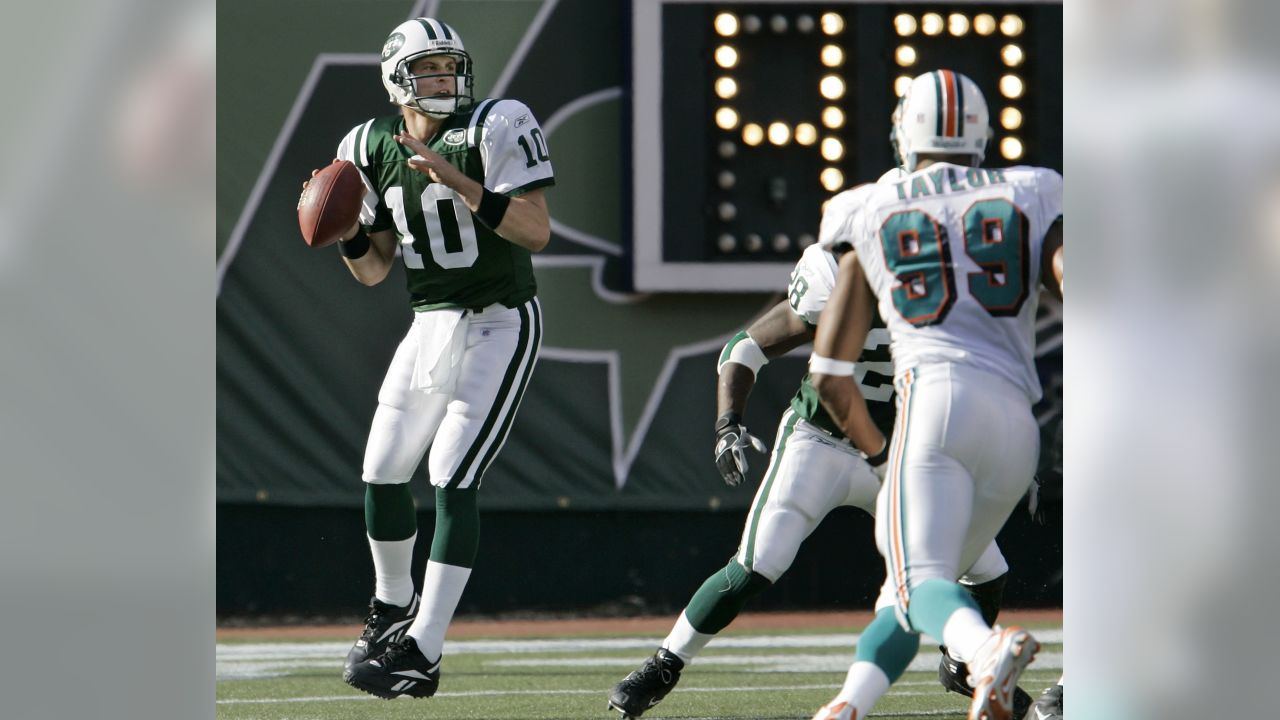 New York Jets head Chad Pennington throws a pass over a leaping Miami  Dolphins Jason Taylor in the first quarter at Giants Stadium in East  Rutherford, New Jersey on October 15, 2006.