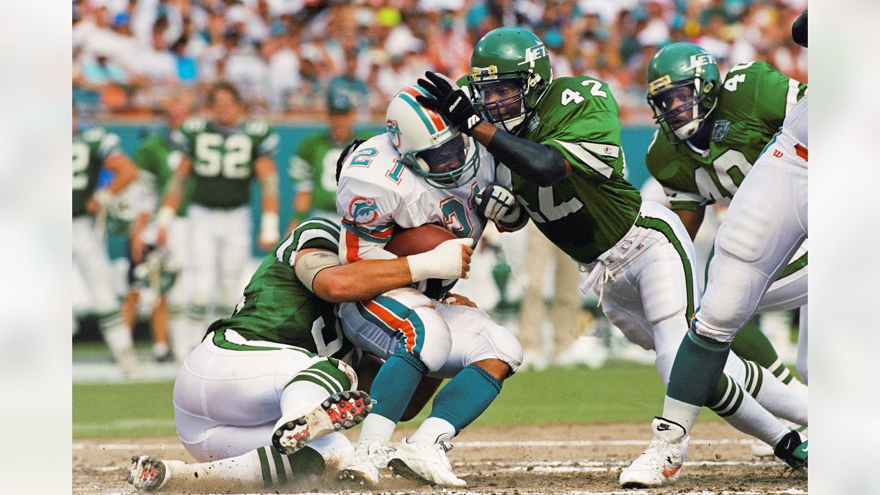 New York Jets Ronnie Lott, right, and teammate Jeff Lageman, left, take  down Miami Dolphins Mark Higgs at Joe Robbie Stadium in Miami, in this  September 13, 1993 photo. Lott will be