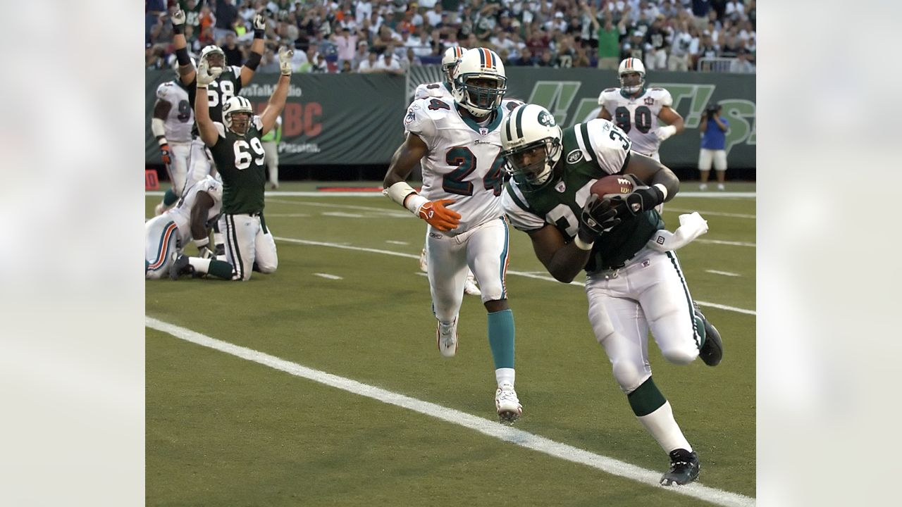 FILE - New York Jets Ronnie Lott (42) and Jeff Lageman, left, bring down Miami  Dolphins Mark Higgs (21) during the first half of an NFL football game in  Miami, Sept. 12