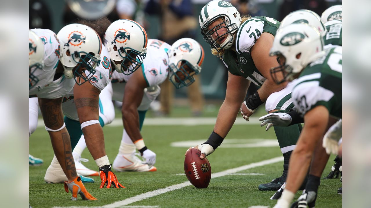 FILE - New York Jets Ronnie Lott (42) and Jeff Lageman, left, bring down Miami  Dolphins Mark Higgs (21) during the first half of an NFL football game in  Miami, Sept. 12