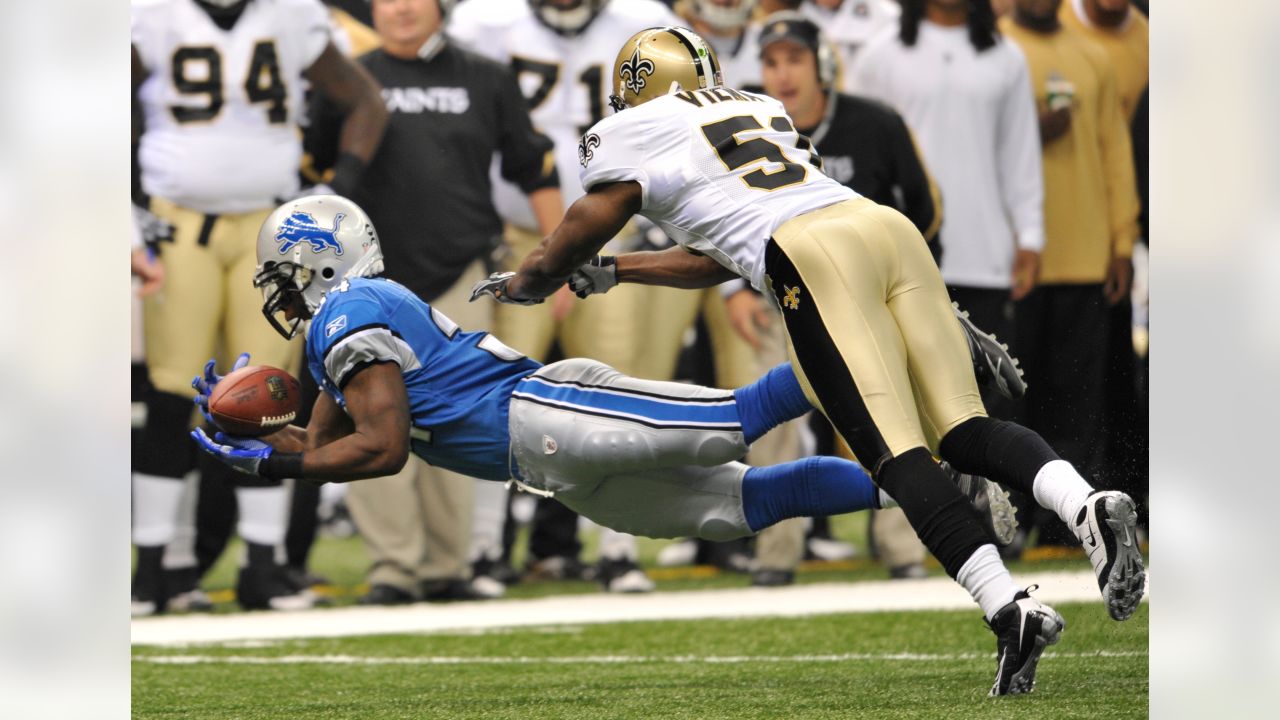 Detroit Lions running back Billy Sims (20) leaps over New Orleans Saints  tacklers in the fourth quarter on, Oct. 12, 1980 in Pontiac, Minnesota.  Simms scored on the play, and Detroit defeated