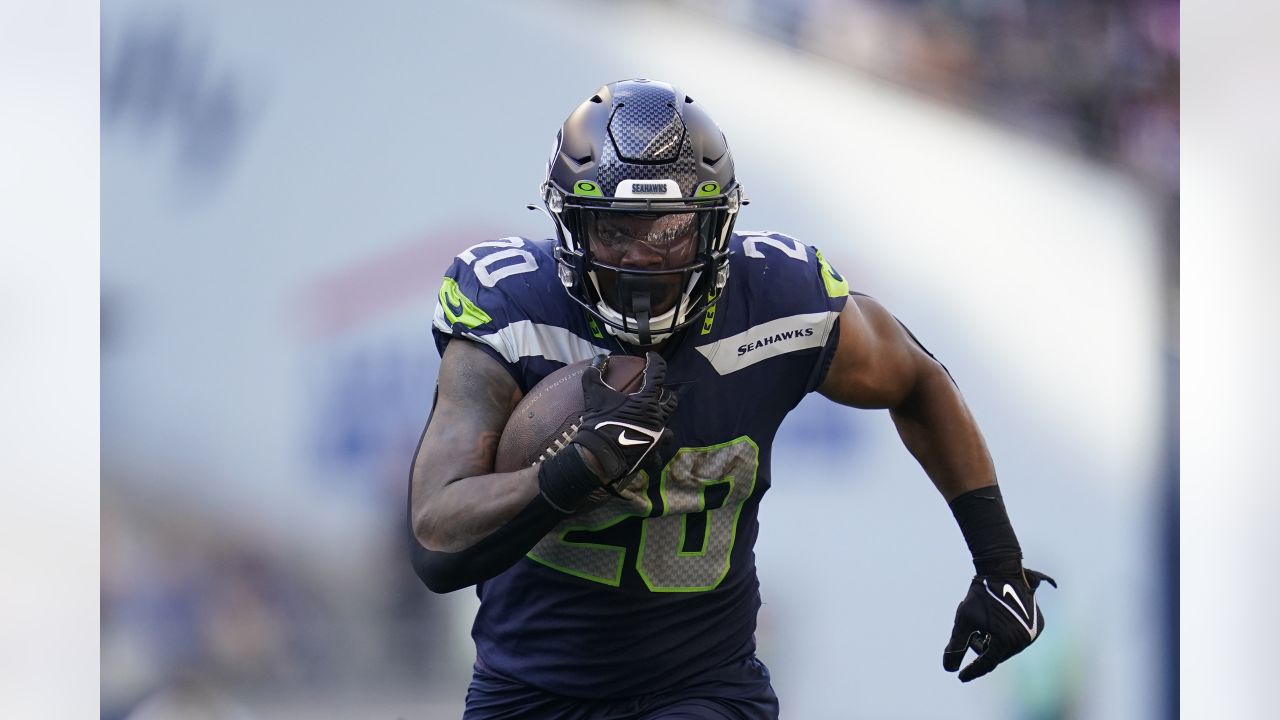 Travis Homer of the Seattle Seahawks looks on before their game