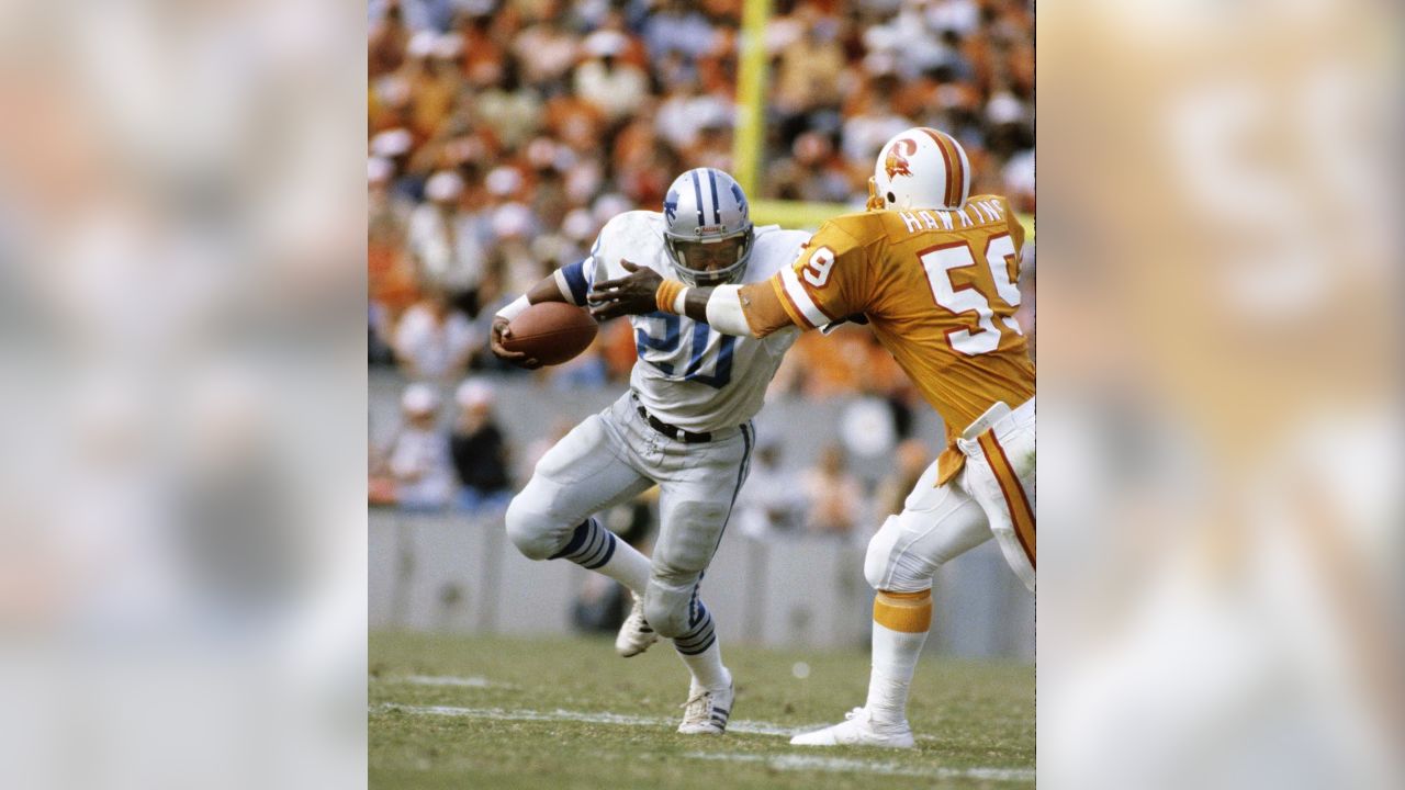 Detroit Lions' Billy Sims tries to elude the grasp of Tampa Bay Buccaneer  defender Scot Brantley in the second quarter but Sims was brought down  after a short run in Tampa, Florida