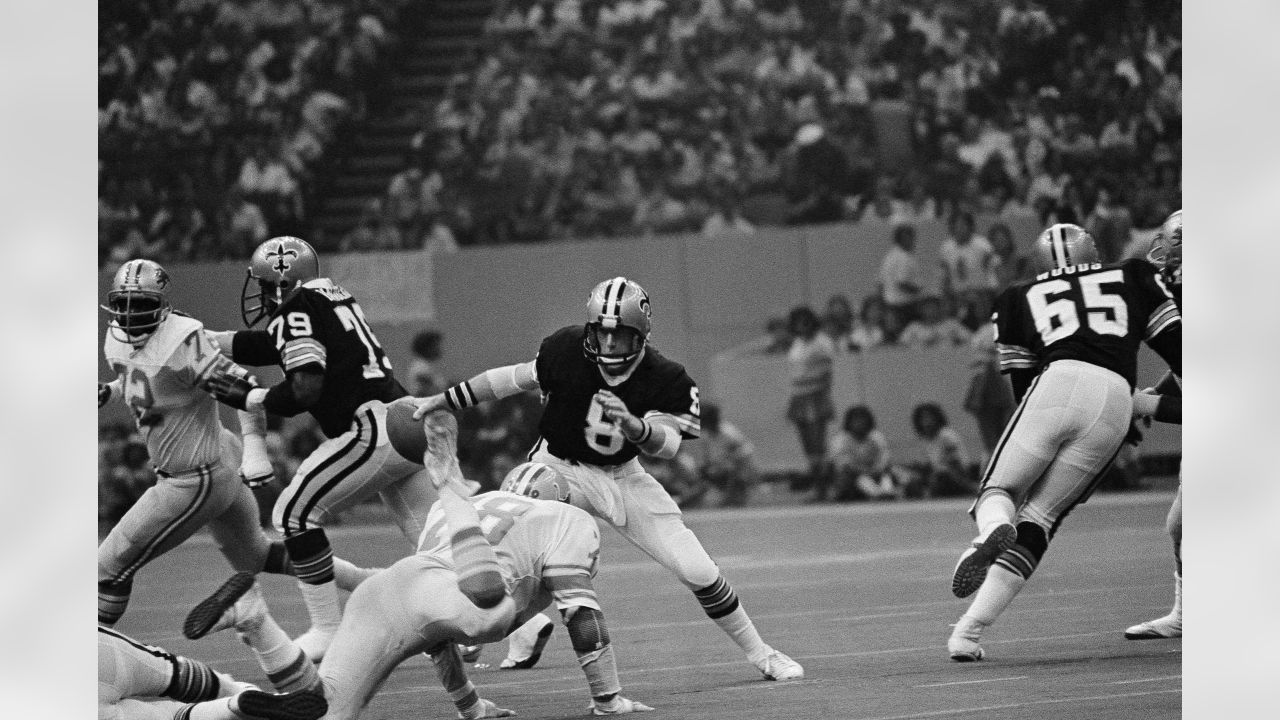 Detroit Lions running back Billy Sims (20) leaps over New Orleans Saints  tacklers in the fourth quarter on, Oct. 12, 1980 in Pontiac, Minnesota.  Simms scored on the play, and Detroit defeated