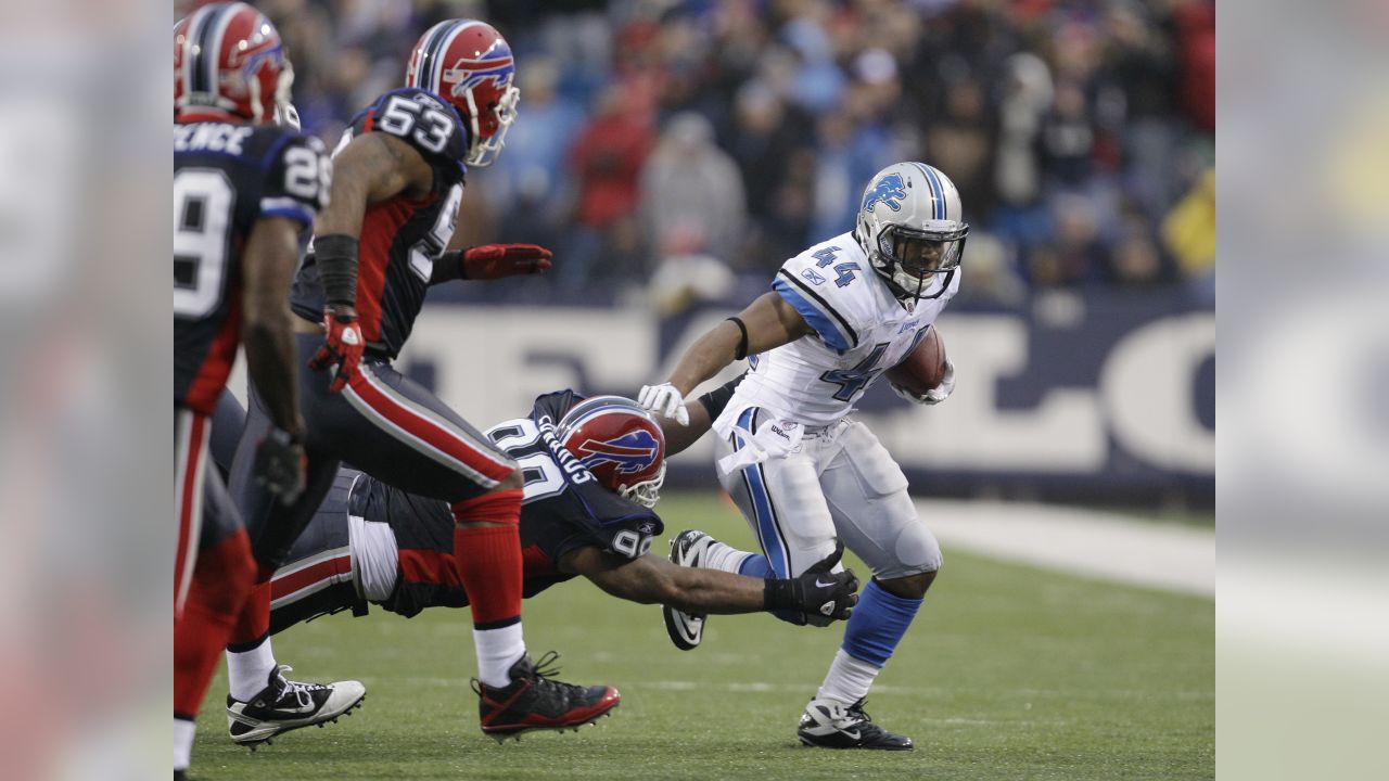 Detroit Lions running back Kevin Jones, (34) breaks away from Buffalo Bills  linebacker Angelo Crowell for a 7-yard touchdown in the first quarter of  their NFL football game in Detroit, Sunday, Oct.