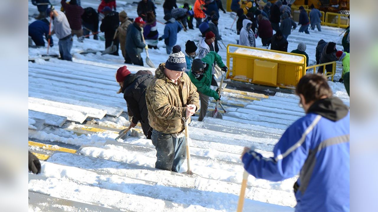 Fans shovel the frozen tundra of Lambeau Field