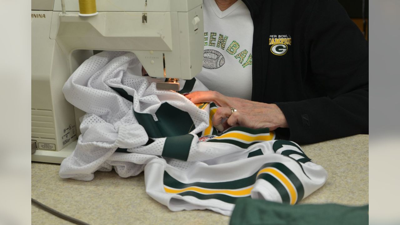 Sewing the captain patches on the road - Green Bay Packers