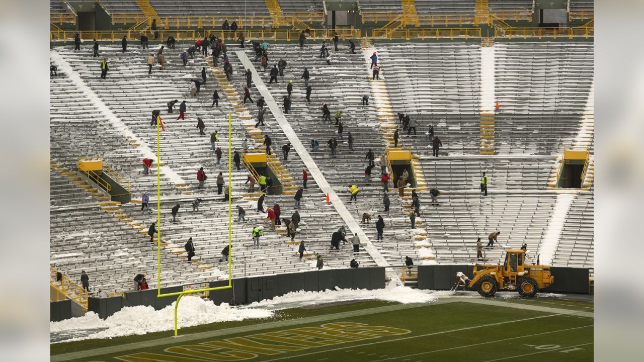 Fans shovel the frozen tundra of Lambeau Field