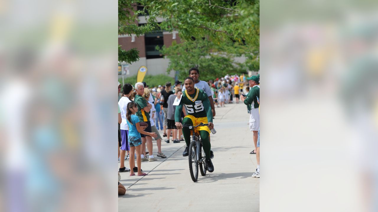 Reggie White on a bike at training camp. RIP to the Minister of