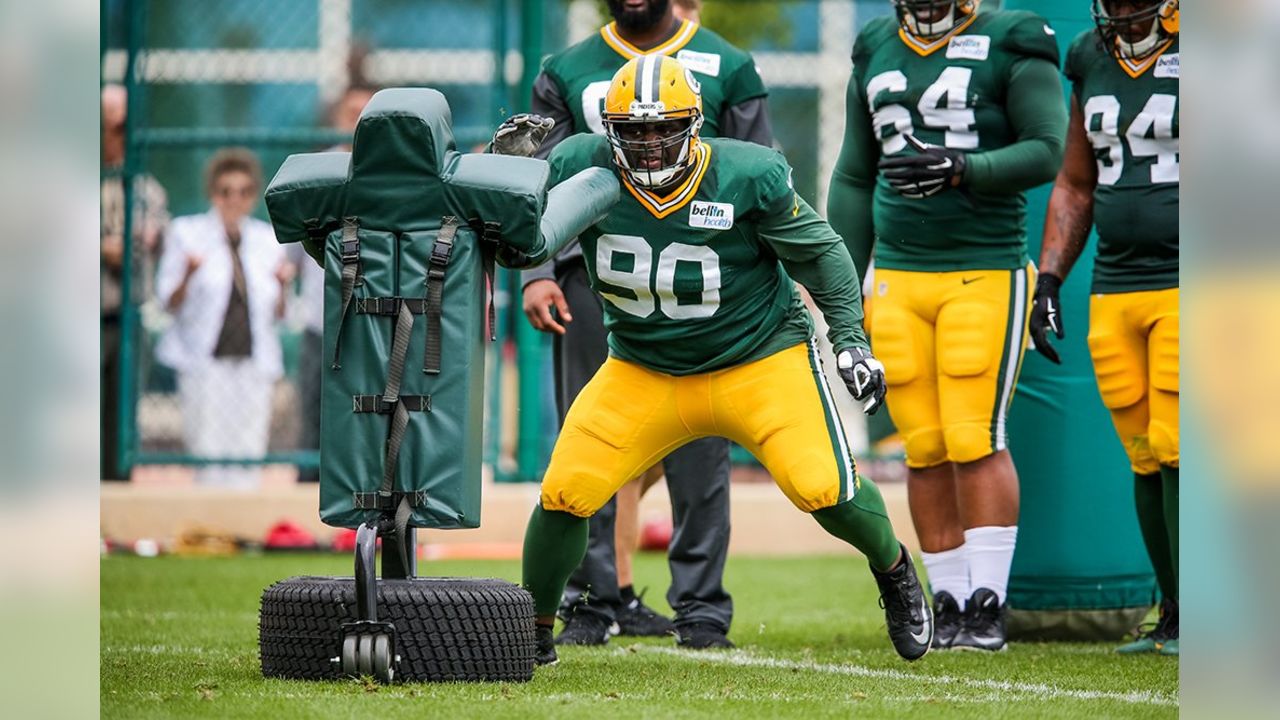 Green Bay Packers B.J. Raji is   hit for his touchdown dance