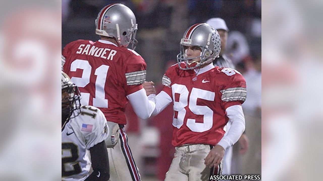 Green Bay Packers holder B.J. Sander watches as kicker Ryan