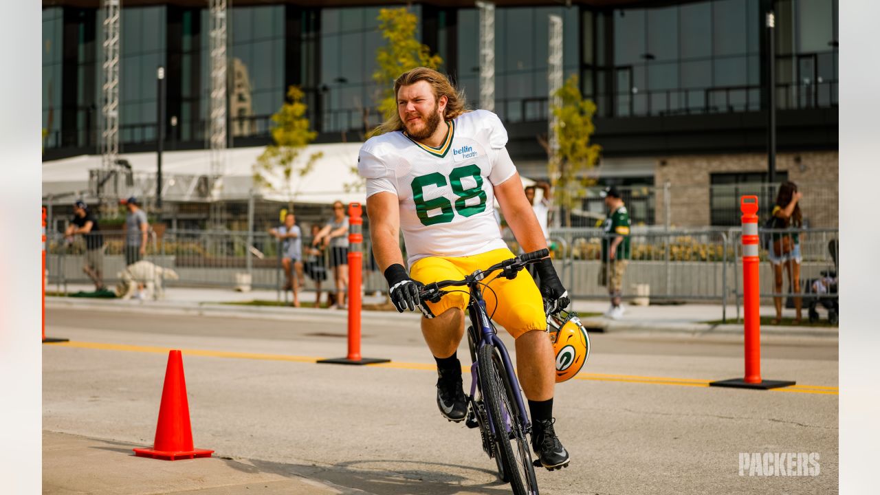 Big guys on bikes: Packers ride to training camp