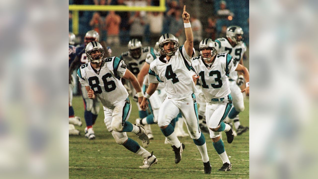 Carolina Panthers kicker John Kasay (4) and holder Ken Walter (13)  celebrate Kasay's 61-yard field goal on the final play of the game to  defeat the New England Patriots 23-20 at Ericsson