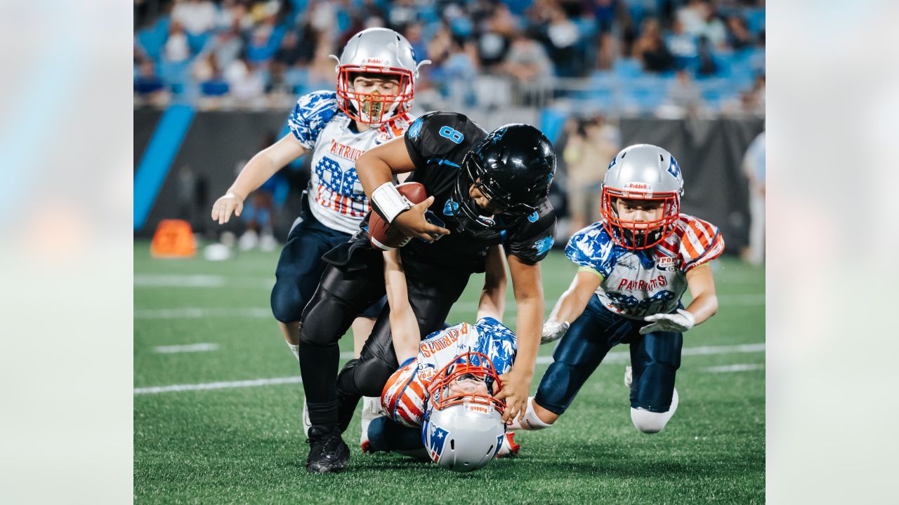 PHOTOS: Greg Olsen, Luke Kuechly coach youth football team at halftime