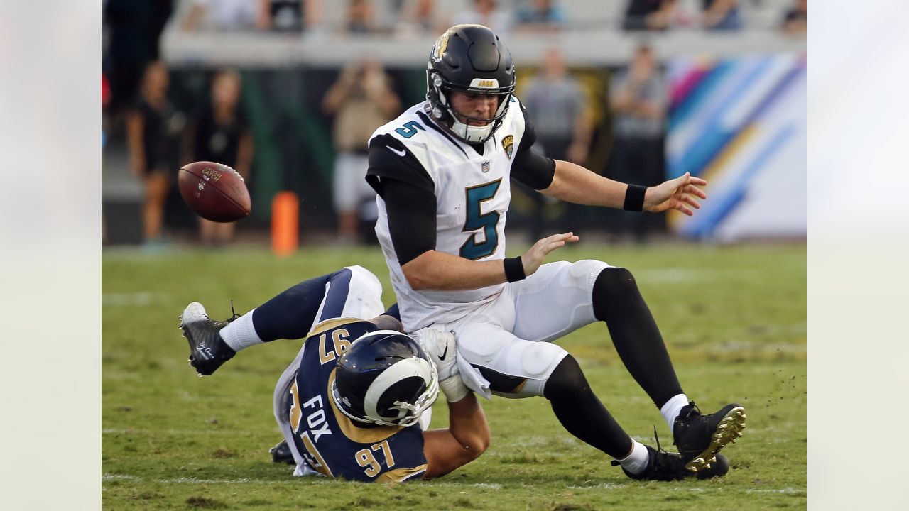 Defensive end Morgan Fox of the Carolina Panthers hits quarterback