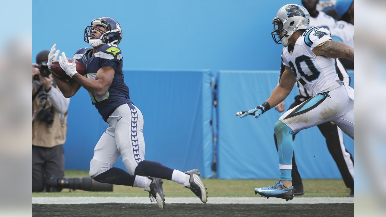 Carolina Panthers safety Tre Boston tackles Seattle Seahawks wide receiver  Tyler Lockett for a loss of yards in the first quarter of a NFC divisional  playoff football game at Bank of America