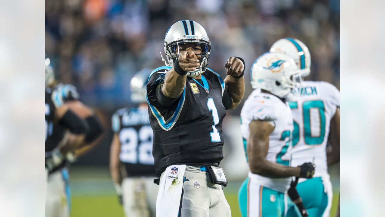 Miami Dolphins players and coaches wear camouflage as a Salute To Service  as they warm up before an NFL football game against the Carolina Panthers  in Charlotte, N.C., Monday, Nov. 13, 2017. (