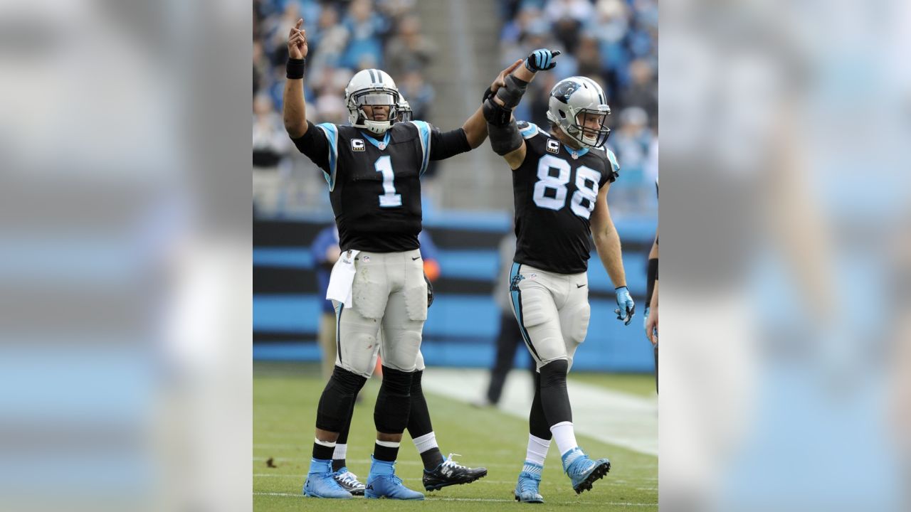 Carolina Panthers' Greg Olsen (88) celebrates with Cam Newton (1) after  Olsen passed 1,000 yards receiving in the first half of an NFL football  game against the Atlanta Falcons in Charlotte, N.C., …