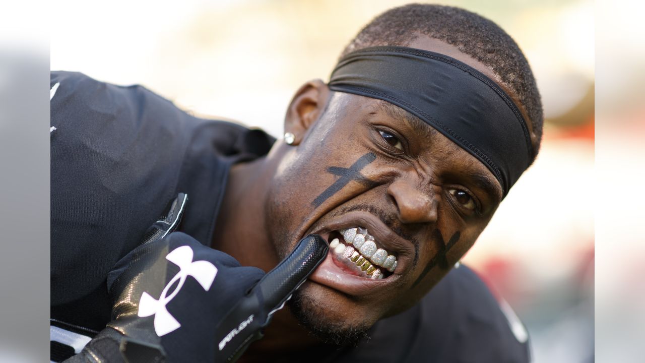 NFL player Tahir Whitehead gestures as he coaches a young team during the  final tournament for the UK's NFL Flag Championship, featuring qualifying  teams from around the country, at the Tottenham Hotspur